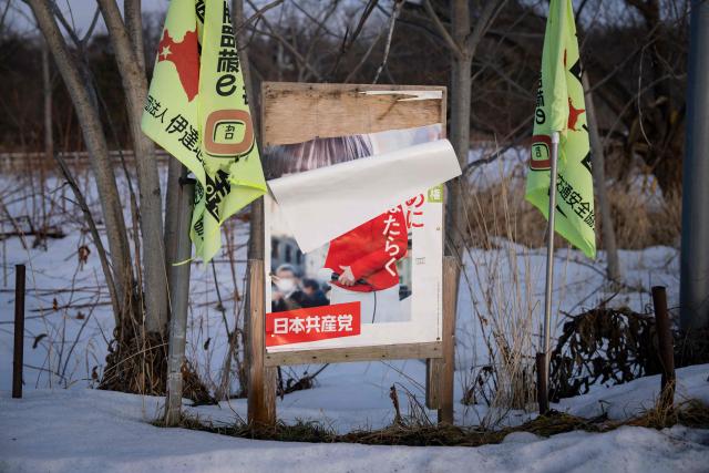 The poster of the opposition Japanese Communist Party is seen partly peeled off from a board in Date, Hokkaido prefecture in northern Japan on February 22, 2026. (Photo by Yuichi YAMAZAKI / AFP)