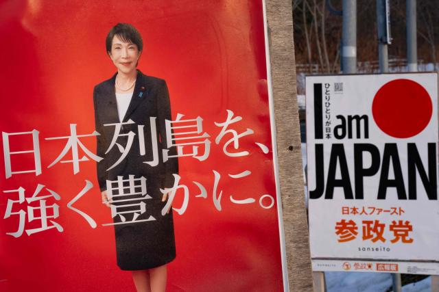 A Liberal Democratic Party (LDP) poster board (L) featuring Japan's Prime Minister Sanae Takaichi is seen past a Sanseito Party poster in Date, Hokkaido prefecture in northern Japan on February 22, 2026. (Photo by Yuichi YAMAZAKI / AFP)