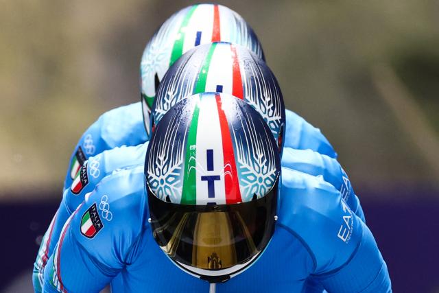 Italy's Lorenzo Bilotti, Italy's Eric Fantazzini and Italy's Robert Mircea seat behind Italy's Patrick Baumgartner as they compete in the bobsleigh men's 4-man heat 3 at Cortina Sliding Centre during the Milano Cortina 2026 Winter Olympic Games in Cortina d'Ampezzo on February 22, 2026. (Photo by FRANCK FIFE / AFP)