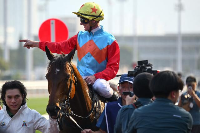 Ka Ying Rising's jockey Zac Purton gestures after winning the Queen's Silver Jubilee Cup horse race at Sha Tin Racecourse in Hong Kong on February 22, 2026. Ka Ying Rising, ridden by Zac Purton, stormed to his 18th win in a row on February 22 to break the long-standing Hong Kong record of Silent Witness. (Photo by Peter PARKS / AFP)