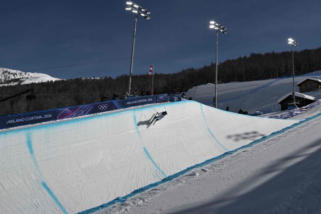 China's Zhang Kexin competes in the freestyle skiing women's freeski halfpipe final run 1 during the Milano Cortina 2026 Winter Olympic Games at Livigno Snow Park, in Livigno (Valtellina), on February 22, 2026. (Photo by Jeff PACHOUD / AFP)