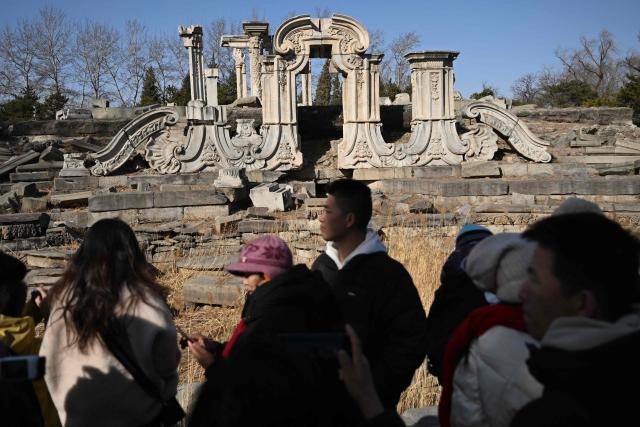 People visit the ruins of the Old Summer Palace at Yuanmingyuan Park on the sixth day of the Lunar New Year of the Horse in Beijing on February 22, 2026. (Photo by Pedro PARDO / AFP)