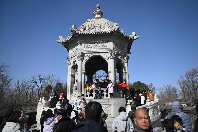 People visit the Old Summer Palace at Yuanmingyuan Park on the sixth day of the Lunar New Year of the Horse in Beijing on February 22, 2026. (Photo by Pedro PARDO / AFP)