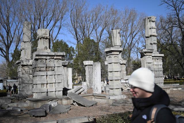 A man visits the ruins of the Old Summer Palace at Yuanmingyuan Park on the sixth day of the Lunar New Year of the Horse in Beijing on February 22, 2026. (Photo by Pedro PARDO / AFP)