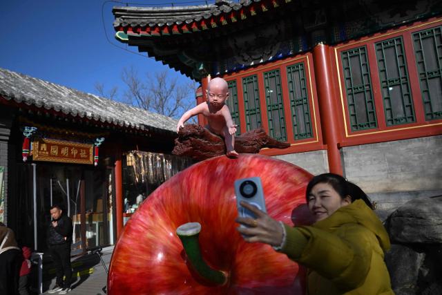 People visit a temple fair on the sixth day of the Lunar New Year of the Horse in Beijing on February 22, 2026. (Photo by Pedro PARDO / AFP)