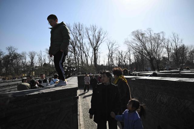 People visit the labyrinth of the ruins of the Old Summer Palace at Yuanmingyuan Park on the sixth day of the Lunar New Year of the Horse in Beijing on February 22, 2026. (Photo by Pedro PARDO / AFP)