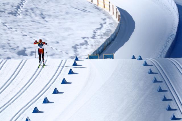 Canada's Amelia Wells competes during the women's cross country 50km mass start final event of the Milano Cortina 2026 Winter Olympic Games at Tesero Cross-Country Skiing Stadium in Lago di Tesero (Val di Fiemme), on February 22, 2026. (Photo by Anne-Christine POUJOULAT / AFP)
