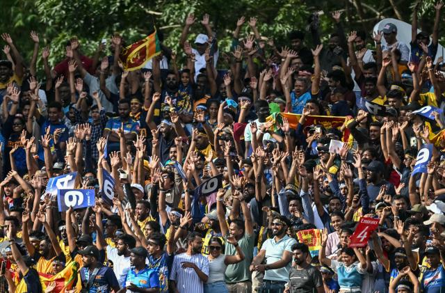 Sri Lankan fans cheer from the stands during the 2026 ICC Men's T20 Cricket World Cup Super Eights match between Sri Lanka and England at Pallekele International Cricket Stadium in Kandy on February 22, 2026. (Photo by Dibyangshu SARKAR / AFP)