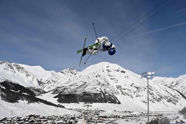 China's Gu Ailing Eileen competes in the freestyle skiing women's freeski halfpipe final run 3 during the Milano Cortina 2026 Winter Olympic Games at Livigno Snow Park, in Livigno (Valtellina), on February 22, 2026. (Photo by Jeff PACHOUD / AFP)