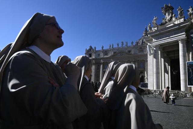 Nuns wait for Pope Leo XIV Angelus prayer from the window of the apostolic palace overlooking St. Peter's square in The Vatican on February22, 2026. (Photo by Filippo MONTEFORTE / AFP)
