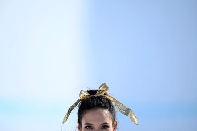 Gold medallist China's Gu Ailing Eileen celebrates on the podium after winning the freestyle skiing women's freeski halfpipe final during the Milano Cortina 2026 Winter Olympic Games at Livigno Snow Park, in Livigno (Valtellina), on February 22, 2026. (Photo by Kirill KUDRYAVTSEV / AFP)