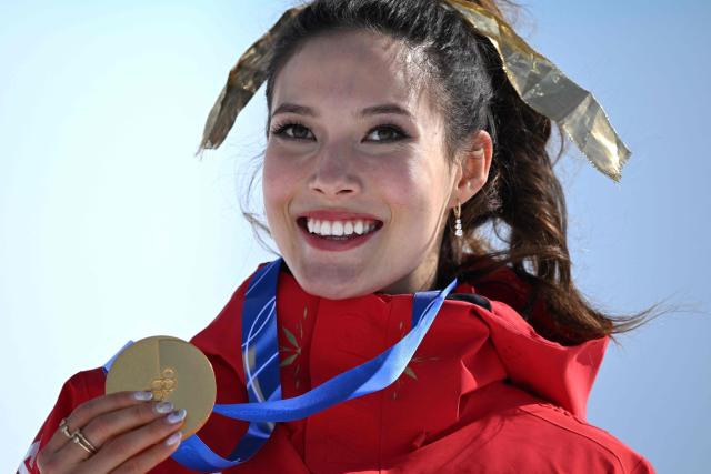 Gold medallist China's Gu Ailing Eileen celebrates on the podium after winning the freestyle skiing women's freeski halfpipe final during the Milano Cortina 2026 Winter Olympic Games at Livigno Snow Park, in Livigno (Valtellina), on February 22, 2026. (Photo by Kirill KUDRYAVTSEV / AFP)