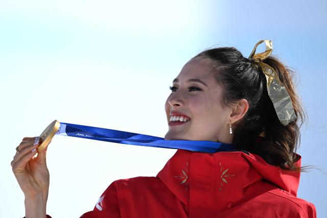 Gold medallist China's Gu Ailing Eileen celebrates on the podium after winning the freestyle skiing women's freeski halfpipe final during the Milano Cortina 2026 Winter Olympic Games at Livigno Snow Park, in Livigno (Valtellina), on February 22, 2026. (Photo by Kirill KUDRYAVTSEV / AFP)