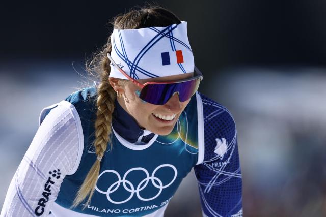 France's Justine Gaillard reacts after crossing the finish line during the women's cross country 50km mass start final event of the Milano Cortina 2026 Winter Olympic Games at Tesero Cross-Country Skiing Stadium in Lago di Tesero (Val di Fiemme), on February 22, 2026. (Photo by Anne-Christine POUJOULAT / AFP)