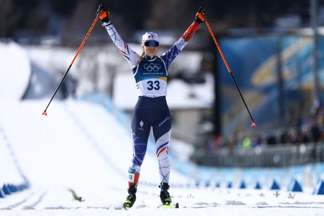 France's Justine Gaillard reacts after crossing the finish line during the women's cross country 50km mass start final event of the Milano Cortina 2026 Winter Olympic Games at Tesero Cross-Country Skiing Stadium in Lago di Tesero (Val di Fiemme), on February 22, 2026. (Photo by Anne-Christine POUJOULAT / AFP)