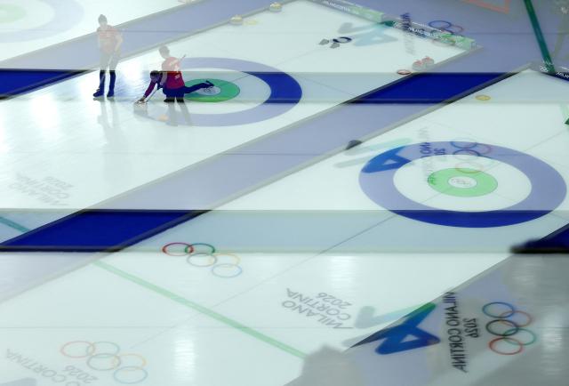 Team Switzerland competes in the curling women's round robin gold medal game between Switzerland and Sweden during the Milano Cortina 2026 Winter Olympic Games at the Cortina Curling Olympic Stadium in Cortina d’Ampezzo on February 22, 2026. (Photo by Odd ANDERSEN / AFP)