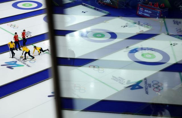 Sweden's Anna Hasselborg (R) delivers the stone in the curling women's round robin gold medal game between Switzerland and Sweden during the Milano Cortina 2026 Winter Olympic Games at the Cortina Curling Olympic Stadium in Cortina d’Ampezzo on February 22, 2026. (Photo by Odd ANDERSEN / AFP)