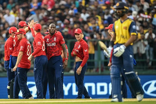England's Jofra Archer (center L) celebrates with teammates after taking the wicket of Sri Lanka's Kamil Mishara during the 2026 ICC Men's T20 Cricket World Cup Super Eights match between Sri Lanka and England at Pallekele International Cricket Stadium in Kandy on February 22, 2026. (Photo by Dibyangshu SARKAR / AFP)