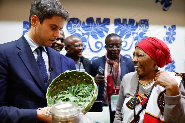 President of Ensemble Pour la Republique parliamentary group Gabriel Attal (L) looks at a handmade basket as he visits the International Agricultural Show (Salon de l'Agriculture) at Paris Expo Porte de Versailles in Paris on February 22, 2026. (Photo by Charlotte SIEMON / AFP)