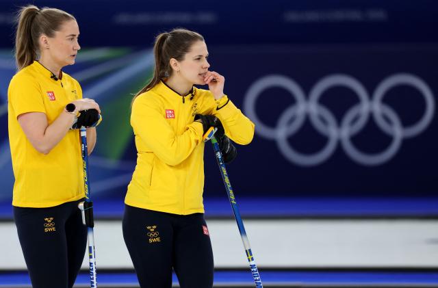 Sweden's Sara McManus and Anna Hasselborg react while competing in the curling women's round robin gold medal game between Switzerland and Sweden during the Milano Cortina 2026 Winter Olympic Games at the Cortina Curling Olympic Stadium in Cortina d’Ampezzo on February 22, 2026. (Photo by Odd ANDERSEN / AFP)