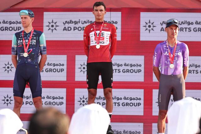Championship first place winner UAE Team Emirates's Mexican rider Isaac Del Toro Romero (C), second place winner Bahrain Victorious's Italian rider Antonio Tiberi (L), and third place winner Team Jayco Alula's Australian rider Lucas Marc Plapp (R) stand on the podium after the seventh and final stage of the UAE Tour cycling event from Zayed National Museum to Abu Dhabi Breakwater in Abu Dhabi on February 22, 2026. (Photo by Fadel SENNA / AFP)