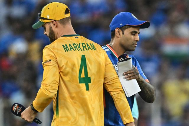 India's captain Suryakumar Yadav (R) shakes hands with his South African counterpart Aiden Markram during the toss before the start of the 2026 ICC Men's T20 Cricket World Cup Super Eights match between India and South Africa at the Narendra Modi Stadium in Ahmedabad on February 22, 2026. (Photo by Manan VATSYAYANA / AFP)