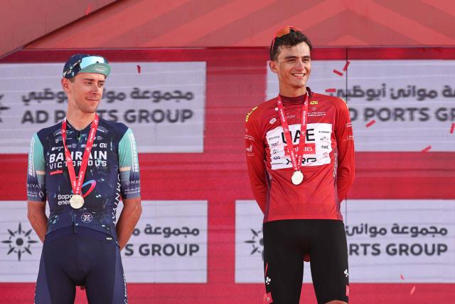 Championship first place winner UAE Team Emirates's Mexican rider Isaac Del Toro Romero (R) and second place winner Bahrain Victorious's Italian rider Antonio Tiberi (L) stand on the podium after the seventh and final stage of the UAE Tour cycling event from Zayed National Museum to Abu Dhabi Breakwater in Abu Dhabi on February 22, 2026. (Photo by Fadel SENNA / AFP)
