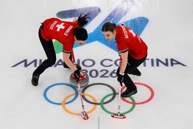 Switzerland's Carole Howald (L) and Selina Witschonke compete in the curling women's round robin gold medal game between Switzerland and Sweden during the Milano Cortina 2026 Winter Olympic Games at the Cortina Curling Olympic Stadium in Cortina d’Ampezzo on February 22, 2026. (Photo by Franзois-Xavier MARIT / AFP)