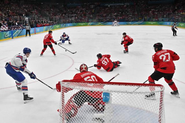 Canada's #97 Connor McDavid (3R) passes the puck to Canada's #17 Macklin Celebrini during the men's gold medal ice hockey match between Canada and USA at the Milano Santagiulia Ice Hockey Arena during the Milano Cortina 2026 Winter Olympic Games in Milan, on February 22, 2026. (Photo by JULIEN DE ROSA / POOL / AFP)