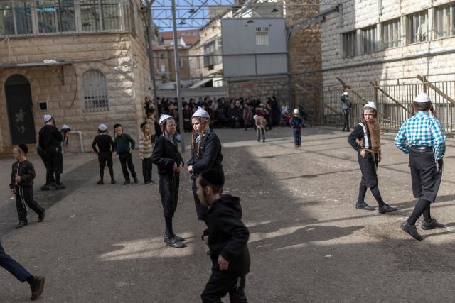 Ultra-Orthodox Jewish children play in the courtyard of a yeshiva in Jerusalem's Mea Shearim neighbourhood on February 22, 2026. (Photo by ilia YEFIMOVICH / AFP)