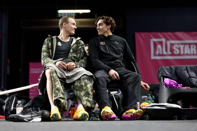 Sweden's Armand Duplantis laughs with US Sam Kendricks (L) before the Men's pole vault event during the All Stars Perche international indoor athletics pole vaulting meeting in Clermont-Ferrand, central France, on February 22, 2026. (Photo by Alex MARTIN / AFP)
