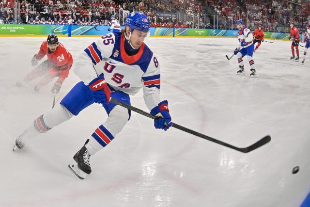USA's #85 Jake Sanderson controls the puck during the men's gold medal ice hockey match between Canada and USA at the Milano Santagiulia Ice Hockey Arena during the Milano Cortina 2026 Winter Olympic Games in Milan, on February 22, 2026. (Photo by Alexander NEMENOV / AFP)