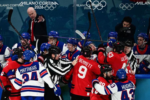 Canada's players and USA's players fight during the men's gold medal ice hockey match between Canada and USA at the Milano Santagiulia Ice Hockey Arena during the Milano Cortina 2026 Winter Olympic Games in Milan, on February 22, 2026. (Photo by JULIEN DE ROSA / AFP)
