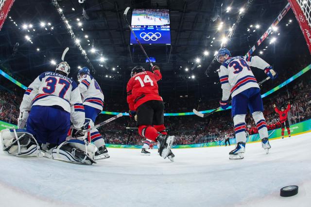 Canada's #14 Bo Horvat (C) reacts after teammate Canada's #08 Cale Makar (out of frame) scored the 1-1 goal during the men's gold medal ice hockey match between Canada and USA at the Milano Santagiulia Ice Hockey Arena during the Milano Cortina 2026 Winter Olympic Games in Milan, on February 22, 2026. (Photo by POOL / AFP)