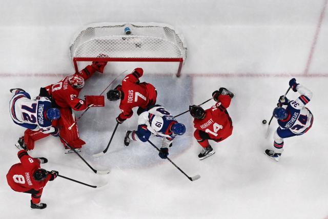 USA's #34 Auston Matthews (R) vies for the puck during the men's gold medal ice hockey match between Canada and USA at the Milano Santagiulia Ice Hockey Arena during the Milano Cortina 2026 Winter Olympic Games in Milan, on February 22, 2026. (Photo by JULIEN DE ROSA / AFP)