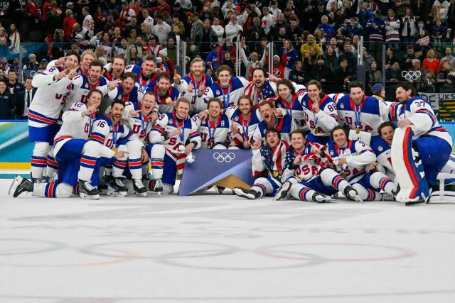 USA's gold medalists celebrate after the medals ceremony of the men's ice hockey event at the Milano Santagiulia Ice Hockey Arena during the Milano Cortina 2026 Winter Olympic Games in Milan, on February 22, 2026. (Photo by Alexander NEMENOV / AFP)