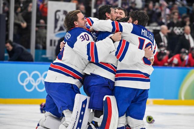 USA players celebrate winning the men's gold medal ice hockey match between Canada and USA at the Milano Santagiulia Ice Hockey Arena during the Milano Cortina 2026 Winter Olympic Games in Milan, on February 22, 2026. (Photo by Alexander NEMENOV / AFP)