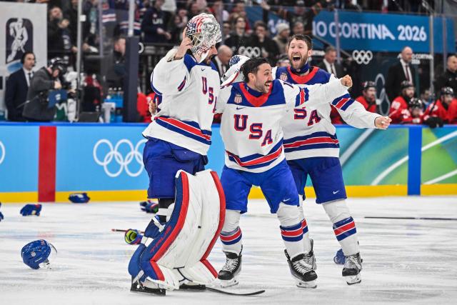 USA players celebrate winning the men's gold medal ice hockey match between Canada and USA at the Milano Santagiulia Ice Hockey Arena during the Milano Cortina 2026 Winter Olympic Games in Milan, on February 22, 2026. (Photo by Alexander NEMENOV / AFP)