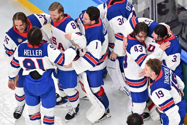 USA's players celebrate after winning the men's gold medal ice hockey match between Canada and USA at the Milano Santagiulia Ice Hockey Arena during the Milano Cortina 2026 Winter Olympic Games in Milan, on February 22, 2026. (Photo by Antonin THUILLIER / AFP)