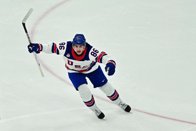 USA's #86 Jack Hughes celebrates after scoring the winning goal  during the men's gold medal ice hockey match between Canada and USA at the Milano Santagiulia Ice Hockey Arena during the Milano Cortina 2026 Winter Olympic Games in Milan, on February 22, 2026. (Photo by JULIEN DE ROSA / AFP)