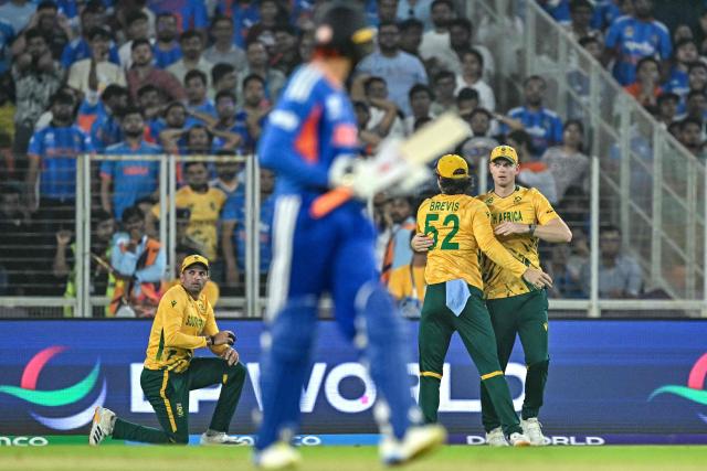 South Africa's Corbin Bosch (R) celebrates with teammates after taking a catch to dismiss India's Abhishek Sharma (2L) during the 2026 ICC Men's T20 Cricket World Cup Super Eights match between India and South Africa at the Narendra Modi Stadium in Ahmedabad on February 22, 2026. (Photo by Manan VATSYAYANA / AFP)