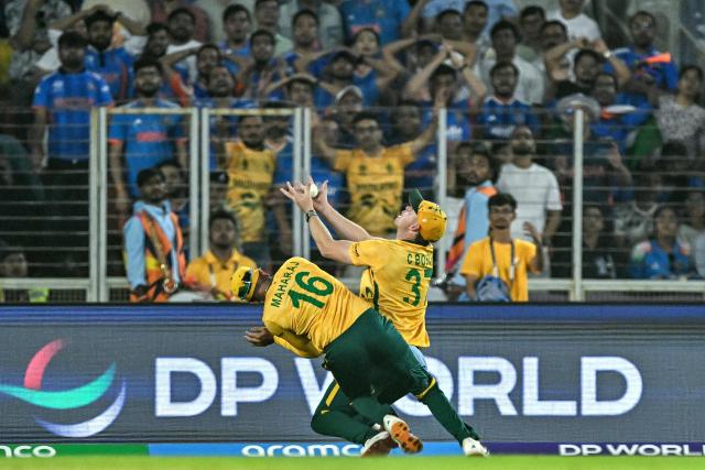 South Africa's Corbin Bosch (R) takes a catch to dismiss India's Abhishek Sharma during the 2026 ICC Men's T20 Cricket World Cup Super Eights match between India and South Africa at the Narendra Modi Stadium in Ahmedabad on February 22, 2026. (Photo by Manan VATSYAYANA / AFP)
