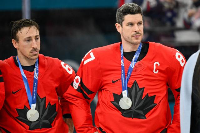 Canada's Brad Marchand (L)  and Canada's Sidney Crosby wear their silver medals during the medals ceremony of the men's ice hockey event at the Milano Santagiulia Ice Hockey Arena during the Milano Cortina 2026 Winter Olympic Games in Milan, on February 22, 2026. (Photo by Alexander NEMENOV / AFP)