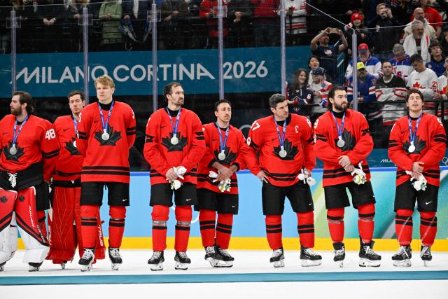 Canada's players look on with their silver medals during the medals ceremony of the men's ice hockey event at the Milano Santagiulia Ice Hockey Arena during the Milano Cortina 2026 Winter Olympic Games in Milan, on February 22, 2026. (Photo by Alexander NEMENOV / AFP)