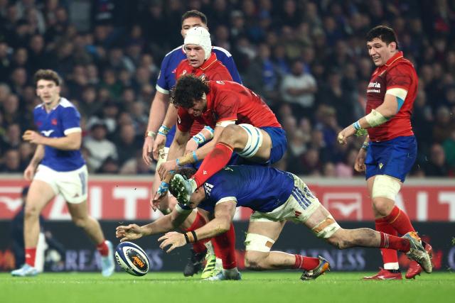 France's flanker Oscar Jegou (bottom) fights for the ball with Italy's lock Andrea Zambonin during the Six Nations international rugby union match between France and Italy at the Stade Pierre-Mauroy in Villeneuve-d'Ascq, northern France, on February 22, 2026. (Photo by Sameer AL-DOUMY / AFP)