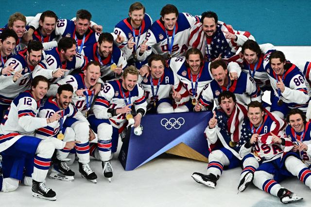 Gold medallists USA's players celebrate  during the medals ceremony of the men's ice hockey event at the Milano Santagiulia Ice Hockey Arena during the Milano Cortina 2026 Winter Olympic Games in Milan, on February 22, 2026. (Photo by JULIEN DE ROSA / AFP)