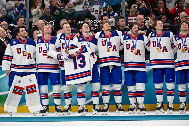 USA's gold medalists celebrate with their medals during the medals ceremony of the men's ice hockey event at the Milano Santagiulia Ice Hockey Arena during the Milano Cortina 2026 Winter Olympic Games in Milan, on February 22, 2026. (Photo by Alexander NEMENOV / AFP)