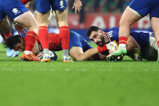 Italy's full-back Ange Capuozzo is tackled by France's lock Charles Ollivon during the Six Nations international rugby union match between France and Italy at the Stade Pierre-Mauroy in Villeneuve-d'Ascq, northern France, on February 22, 2026. (Photo by Sameer AL-DOUMY / AFP)