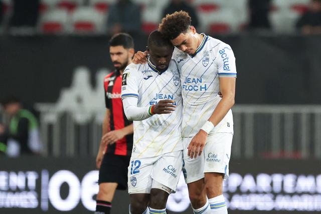 Lorient's Senegalese forward #12 Bamba Dieng (L) celebrates after scoring his team's second goal from the penalty spot during the French L1 football match between OGC Nice and FC Lorient at the Allianz Riviera Stadium in Nice, south-eastern France, on February 22, 2026. (Photo by Valery HACHE / AFP)
