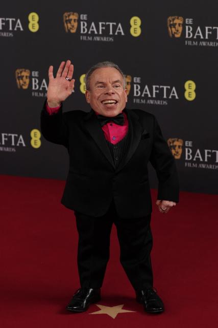 British actor Warwick Davis poses on the red carpet upon arrival at the BAFTA British Academy Film Awards at the Royal Festival Hall, Southbank Centre, in London, on February 22, 2026. (Photo by Adrian Dennis / AFP)